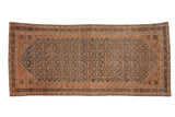 Distressed Malayer runner with a diamond-shaped Herati field in navy blue and pale copper.
