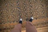 Low pile texture of a vintage Malayer rug's Herati design in copper and indigo blue.