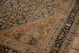 Evenly worn texture on the copper Herati field and deep indigo floral border of a vintage Malayer.
