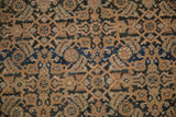 Low, even wear on a hand-knotted Malayer rug showing pale copper and navy Herati designs.