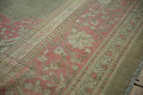 Distressed Armenian Agra border detail with faded pink floral vinery and sage green.