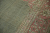 Low pile texture of vintage distressed Armenian Agra rug, dusty sage field, faded magenta border.