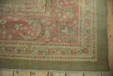 Vintage distressed Armenian Agra carpet corner, with sprawling floral vinery in faded magenta and olive green.