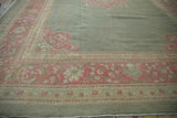 Traditional Armenian Agra rug corner: soft sea foam green field, wide faded pink vinery border.