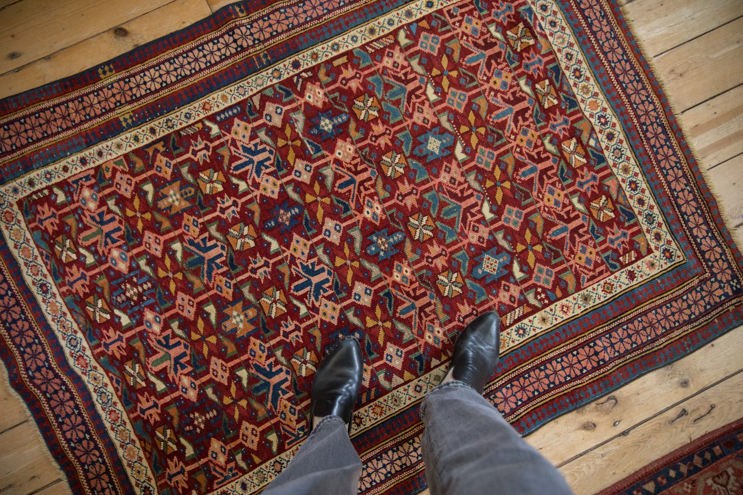 Antique Seichour rug: detailed pinwheel floral and bud motifs, black cherry red field, geometric borders.