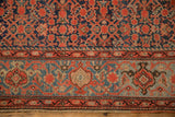 Vintage Malayer carpet's Turtle Samovar border in varied sky blue and a dense red Herati field.