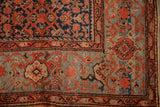 Vintage Malayer carpet corner showing the Turtle Samovar border, Herati field, and low-pile texture.