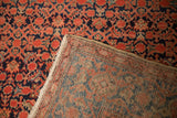 Corner detail of a vintage Malayer carpet revealing its dense hand-knotted foundation.