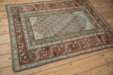 Distressed geometric vine border and lattice field of a vintage Kurd rug corner.