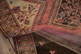 Expressive bird motifs on a distressed vintage rug with blush, beige, and chocolate brown sections.