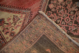 The hand-knotted foundation and distressed pile shown on a folded corner of a vintage Malayer rug.