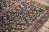 Detailed view of an antique Malayer's Herati field and its serrated leaf and meandering vine borders.