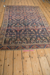 Angled perspective of a fine antique Malayer rug showing its intricate Herati pattern.