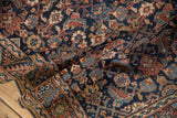 A soft fold in an antique Malayer rug reveals its dense Herati pattern and rich colors.