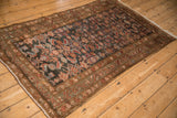 Distressed vintage Hamadan rug detail with intricate Herati design in varied, rich tones.