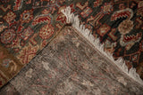 Folded corner view of the hand-knotted foundation and distressed Herati pile of a Hamadan rug.