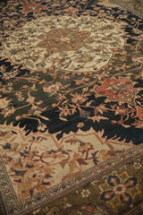 Antique Persian Malayer carpet medallion with ivory ground, navy floral field, and olive green Samovar border.
