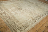 Intricate chocolate brown floral borders and ivory corner spandrel of an antique Kerman rug, displaying character.