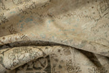 Distressed Kerman carpet, showing soft wool pile, faint foundation, and subtle blue motifs.
