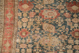 Worn texture of an antique Bijar rug showing oversized palmettes in dusty teal and madder root red.