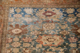 Detailed knotting and antique patina on Harshang design palmettes in dusty teal and chestnut.
