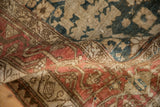 Dense hand-knotted pile of a folded antique Bijar rug with arabesques in dusty red and teal.