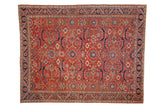 Vintage Persian Heriz carpet with an allover geometric design in cherry red, navy blue, green, and pale gold.