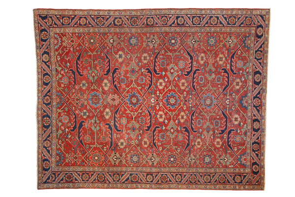 Vintage Persian Heriz carpet with an allover geometric design in cherry red, navy blue, green, and pale gold.