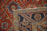 Folded corner of a vintage Heriz carpet showing its hand-knotted pile and woven foundation.