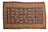 Antique Caucasian rug with colorful navy field, Koneghand design, Kufic border, and serpent motifs.
