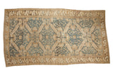 A vintage distressed Kurdish carpet with sprawling quatrefoil medallions in dusty denim blue and antique ivory.