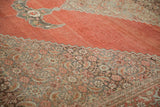 Antique Halvai Bijar carpet's distressed burnt orange field meets an intricate Herati border design.