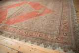 Corner of antique Halvai Bijar carpet: dragon outer border, samovar turtle motif, and edge tatter.