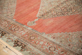 Distressed terra cotta field of the antique Bijar rug with faded samovar turtle border pattern.