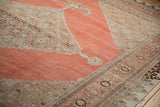 Distressed Halvai Bijar rug with faded terra cotta field and intricate silver-toned borders.