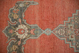 Detail of distressed antique Halvai Bijar rug, burnt orange field, silver-charcoal samovar border motif.