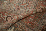Storied wear across knot heads and intricate samovar turtle border of the Halvai Bijar carpet.