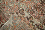 Folded corner of antique Distressed Halvai Bijar carpet, revealing its hand-knotted foundation and worn pile.