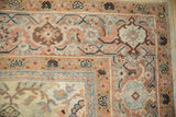 Antique Mahal carpet corner showcasing blossom and meandering vine border in peach, powder blue, and sandalwood.