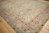 Antique Mahal carpet corner, showing meandering vine border and blossom field in pastel tones.