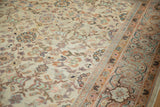 Detailed view of antique Mahal carpet's cream field, featuring Veramin-style blossoms and distinct main border.