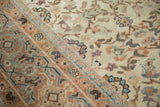 Hand-knotted antique Persian Mahal rug detail with meandering vine border and blossom patterns.