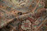 Antique Mahal carpet's hand-knotted pile revealing stylized blossoms in cream, powder blue, and rust.