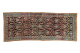 Vintage Northwest Persian rug runner with repeating paisley botehs on a rich chocolate brown field.
