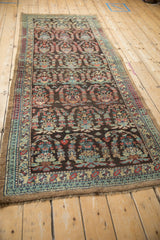 Angled perspective of a vintage Persian runner showing its detailed boteh and tree-of-life motifs.