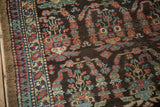 Corner view of the Persian runner's intricate boteh motifs and thin banded border.