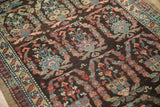 Close-up on the hand-knotted pile of a vintage Persian runner, showing detailed paisley botehs and cloudband elements.