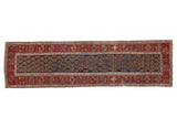 Antique Northwest Persian runner with boteh motifs covering a navy blue field within a wide, red floral border.