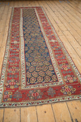 A full perspective of the late 19th-century Persian runner, showing the rhythmic boteh pattern and geometric borders.