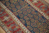 Evenly worn pile showing the navy boteh field and red floral border of an antique Persian runner.